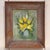 Still life of yellow flowers in a vase by Diana Heiskell, loosely painted against a soft green ground, in a wide wood frame.