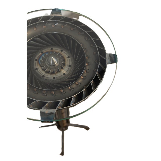 A striking industrial modern pedestal table crafted from repurposed racing components. The base incorporates an authentic...