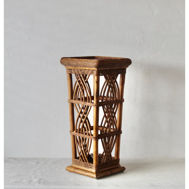 Coastal charm for your space in this stunning woven rattan pedestal. Perfect for displaying plants, sculptures, or...