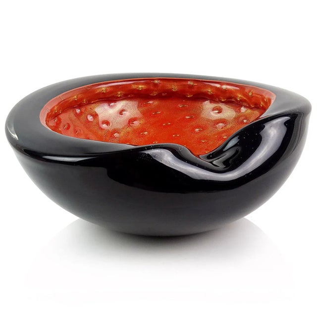 Beautiful Murano hand blown black over persimmon orange and gold flecks Italian art glass decorative bowl. Documented to...