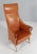 Umberto Asnago for Giorgetti. Lounge chair in patinated saddle leather Frame of beech and armrest details in walnut. Made...
