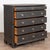 Large black pine chest of five drawers with turned columns flanking the inset upper large two drawers. The four large...