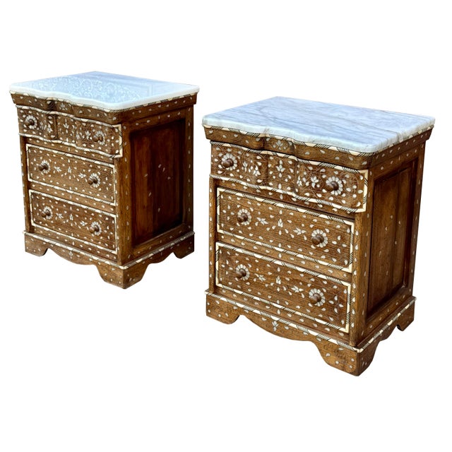 A stunning vintage pair of nightstands featuring three drawers and a natural marble top on each. Crafted from rich walnut...
