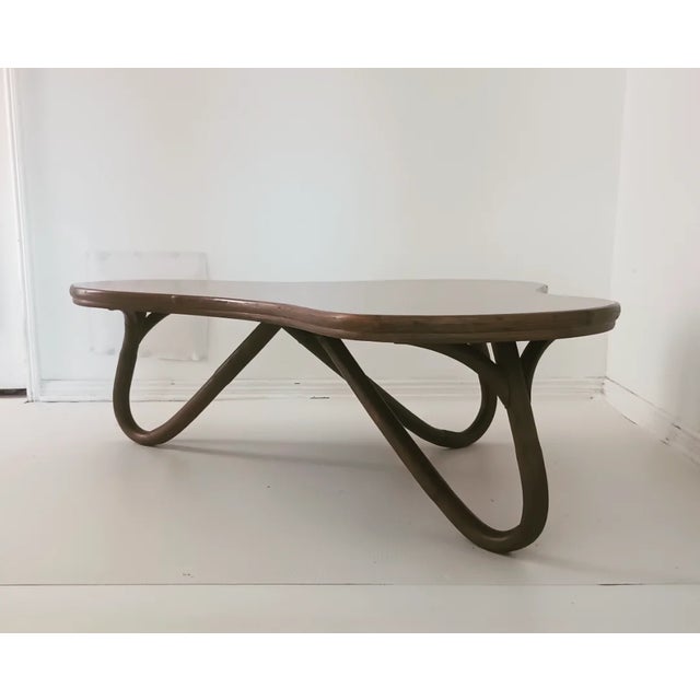 This beautiful, rare table is from the 60s. The bamboo base, frame is on a pretzel design and the top is laminated. This...