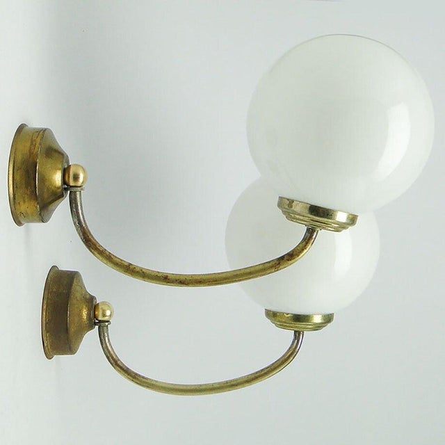 A pair of wall lamps come from the 1950s. They are in good condition. European Plug (up to 250V).The wiring of this item...