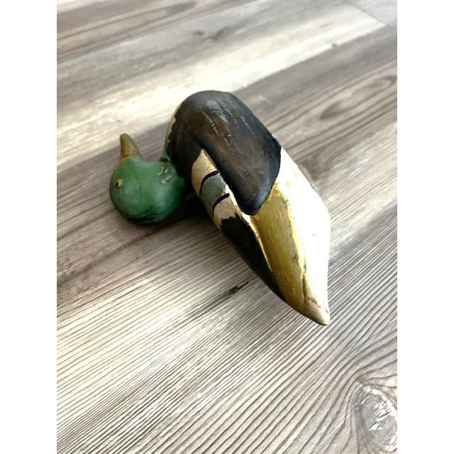 This is a mid 20th century hand-painted wood duck-shaped lint brush. The wooden duck figure has nice detailing with a...