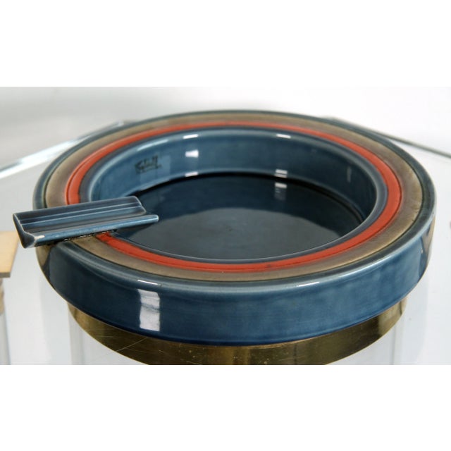 Add a touch of Italian elegance to your home with this 1960's Baldelli Ceramic Ashtray in Stone Blue with brilliant orange...
