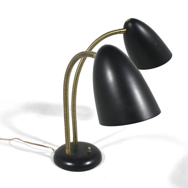 Versen's classic post-war functionalist design, this table lamp has two conical spun-aluminum shades connected to the base...