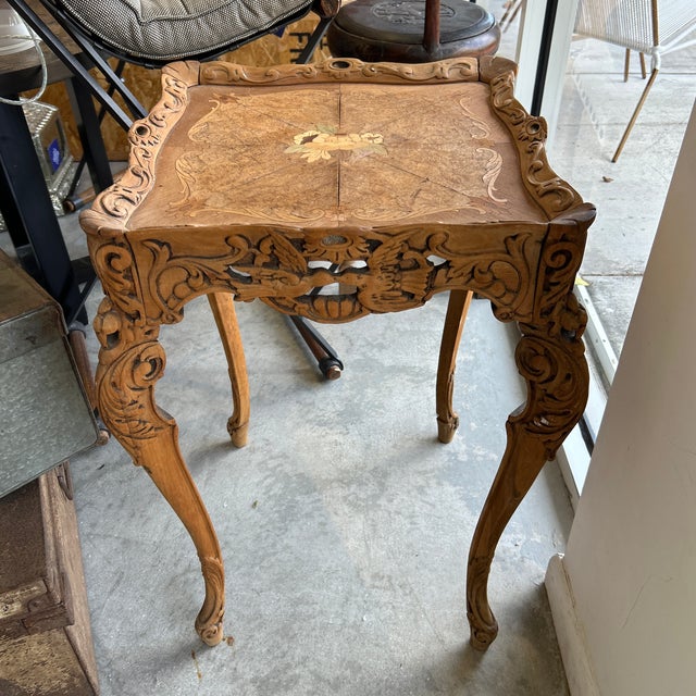 Antique solid wood side table carved with openwork on the wraparound sides. The legs are very shapely and the top has...