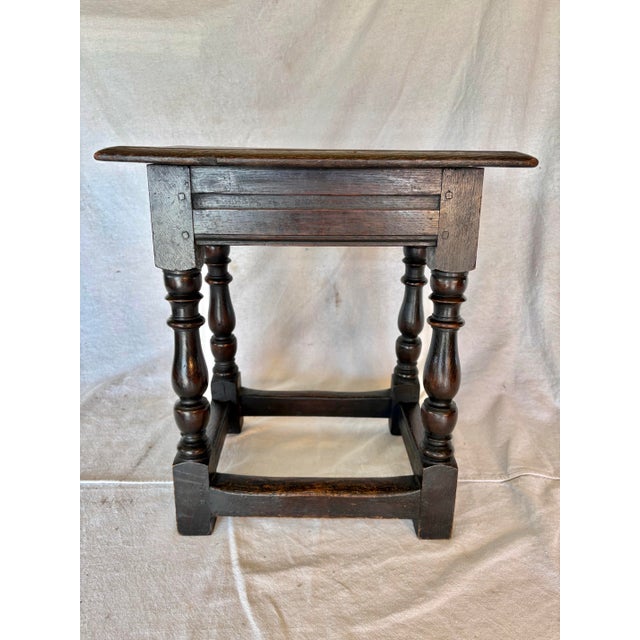 This 18th Century English Oak Joint Stool dates back to the 1700's. The piece is crafted with pegged mortise and tenon...