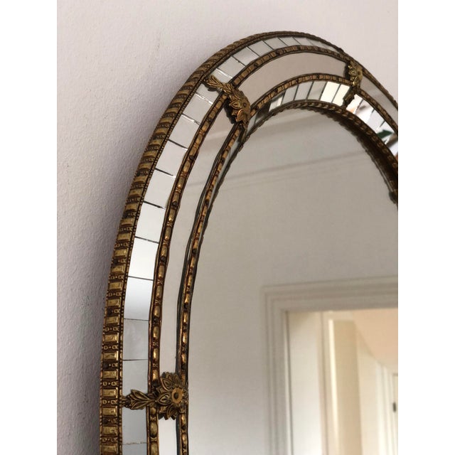 Vintage Venetian beveled large mirror in Spanish style, dating from the 1990s. The handcrafted glass frame is decorated...