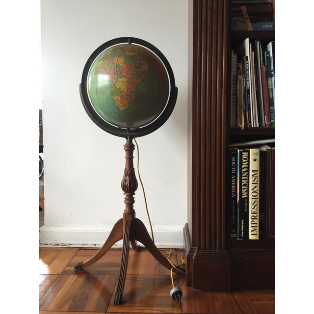 This vintage Replogle 12-inch Precision floor globe is made from a glass orb covered with paper map gores. The world globe...