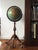 This vintage Replogle 12-inch Precision floor globe is made from a glass orb covered with paper map gores. The world globe...