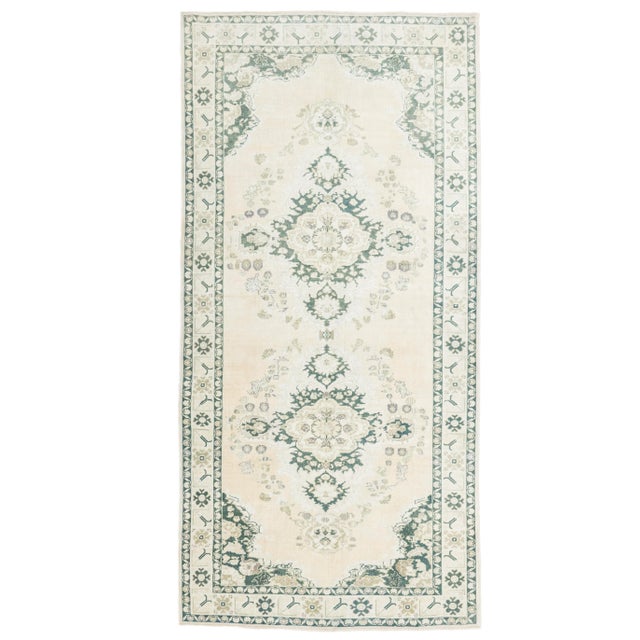 This stunning, hand-knotted vintage Oushak runner rug, measuring 5' 3" x 11' 2", is a beautiful example of classic...