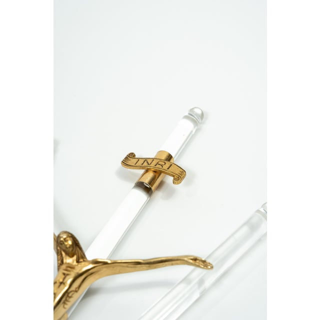 An elegant, decorative wall cross that blends classic religious iconography with modern materials in a Hollywood Regency...