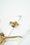 An elegant, decorative wall cross that blends classic religious iconography with modern materials in a Hollywood Regency...