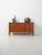 Small Scandinavian teak sideboard from the 1960s, with black lacquered exterior legs, sliding doors, and drawers with oval...