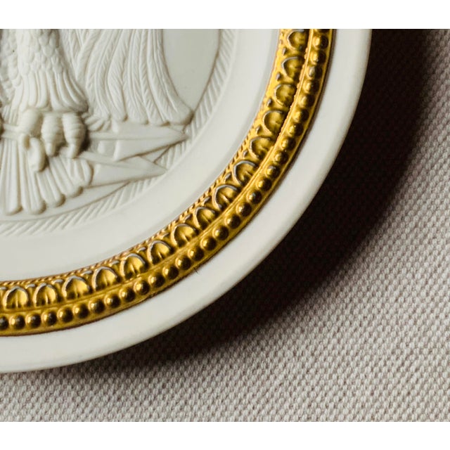 Italian Bisque Porcelain "Grand Tour " Eagle Plaque with Gilt Border | Grand Tour Style | Italy, Mid-20th C. A refined...