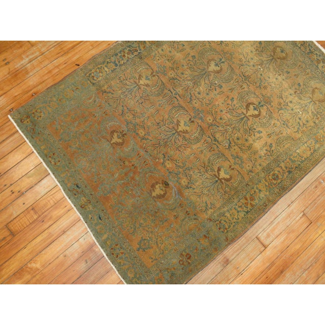 An early 20th century finely woven Decorative Persian Sarouk rug in browns and olive green accents.