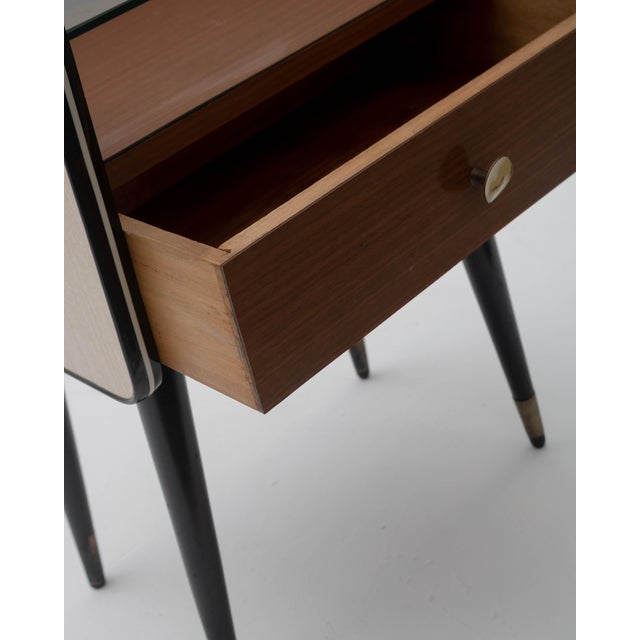 This Italian Mid-Century style nightstand is an exceptional piece of 1960s design that perfectly encapsulates the...