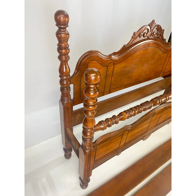 Full-size (double) bed frame dating to the 1930s–1940s Colonial Revival era. This piece features a headboard adorned with...