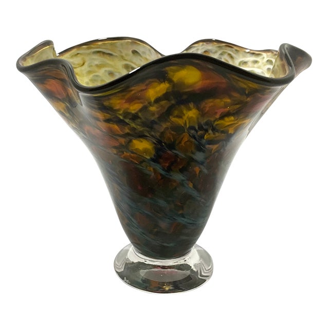 A gorgeous multicolored hand-blown ruffled handkerchief vase. The vase stands 5 1/2 inches tall, is 6 1/2 inches wide, and...