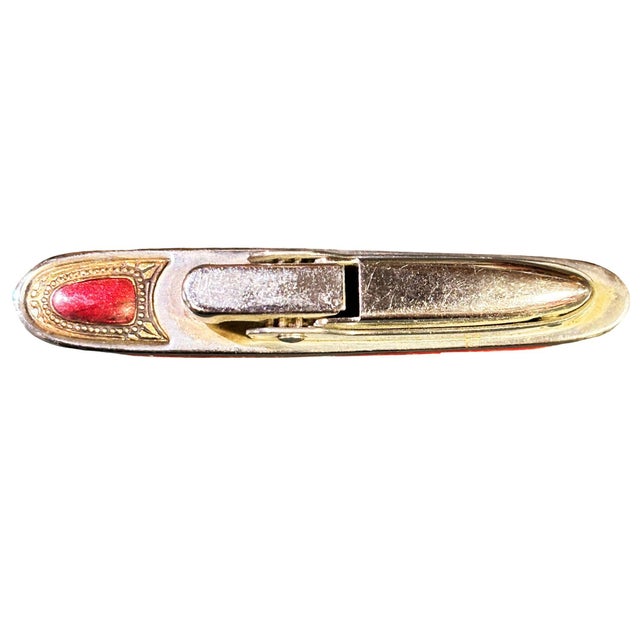 Mid-Century Sarome 'Cruiser' lighter, shaped like a Cruise ship, features a chrome body with enameled red and yellow...