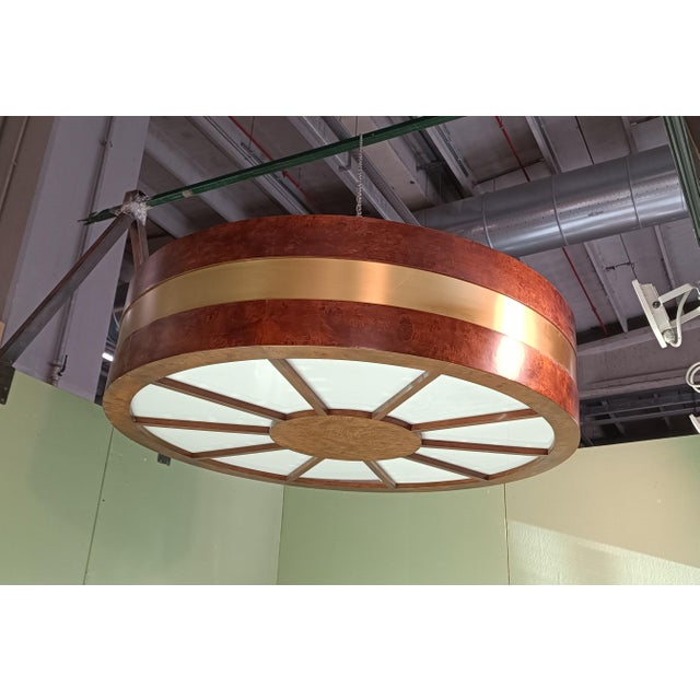Large briar wood chandeliers, circular golden metal band and movable white plexi segments. Each chandelier has 10 plexi...