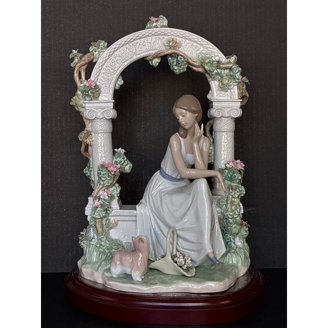 Lladró Tranquility (model #06677) porcelain figurine, featuring a seated woman under a floral arbor. I bought this for my...