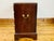 A vintage Chippendale-style four-drawer chest mahogany with a molded top edge, graduated drawers with brass oval-backplate...
