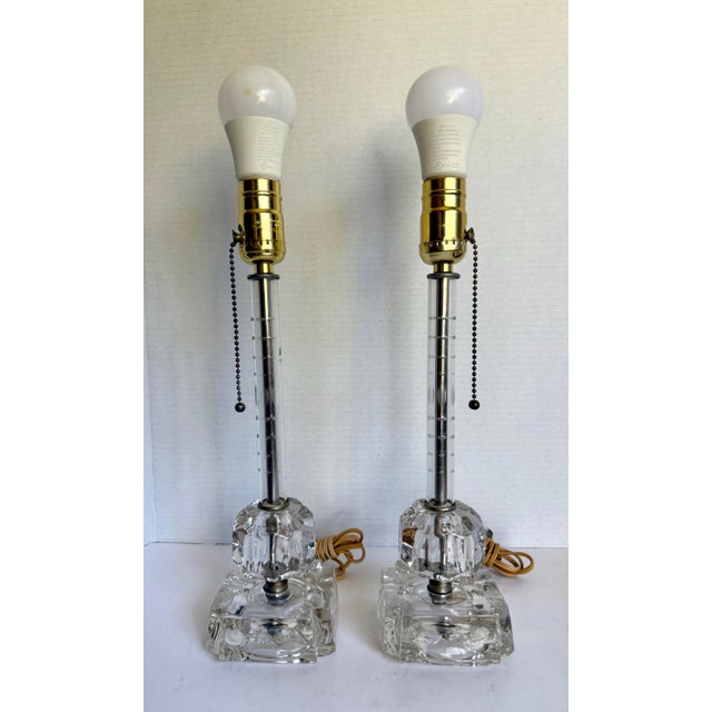 Here is a lovely pair of vintage glass table lamps, likely dating to the mid-20th century, designed in a classic Hollywood...