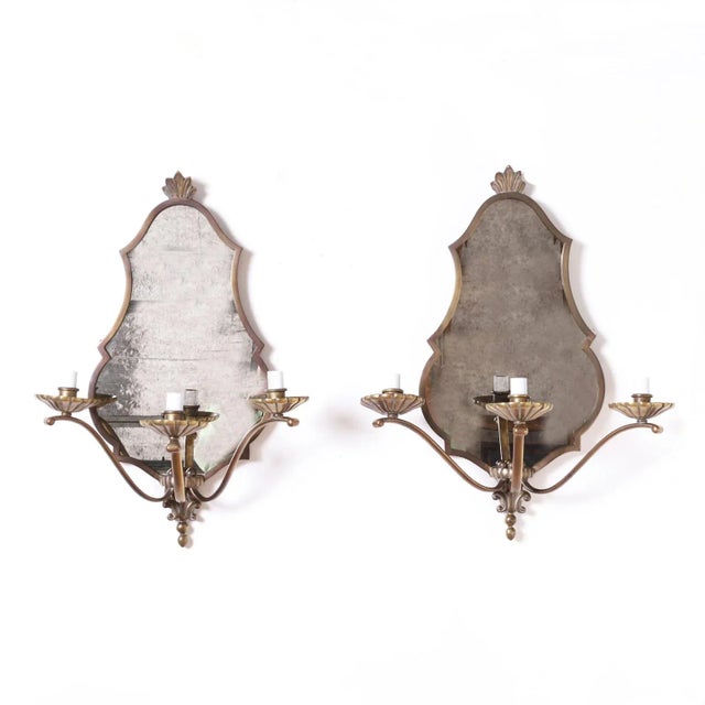 In vogue pair of three arm brass sconces with classic French form having early art deco influences and replaced distressed...