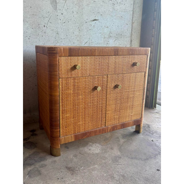 A refined vintage bedside chest by Bielecky Brothers, known for their high-quality rattan furniture and timeless Palm...
