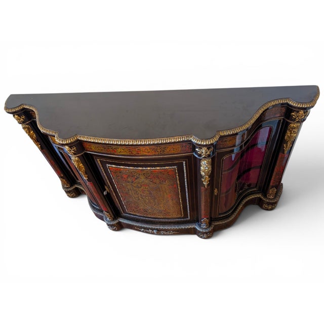 This splendid piece of furniture is a three-door sideboard with a curved front, crafted in the sumptuous boulle style,...