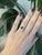 A 1.05ct zambian emerald emerald cut ring set in solid 14K yellow gold, set with ten earth mined diamonds. Emerald, the...