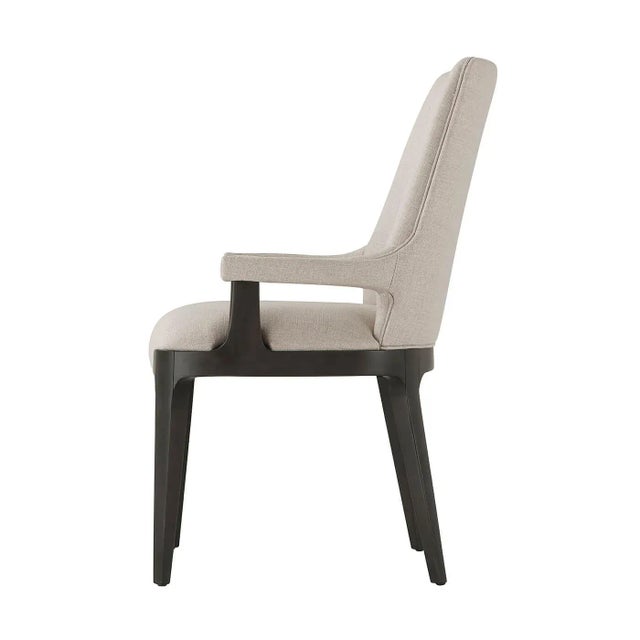 Modern Upholstered Dining Armchair with solid beech and a dark Macadamia finish. With a scoop barrel back and tightly...