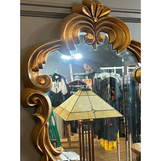 Italian Hollywood Regency style gold tone, ornate mirror Made from a composite material This is in good condition. Please...