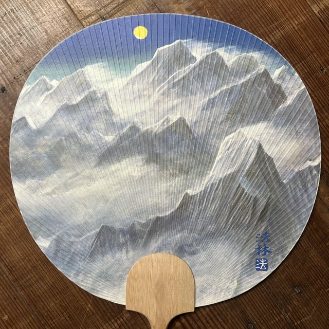 A rare and refined uchiwa (round paddle fan) from Japan, made for the prestigious Takashimaya department store in the...
