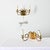 A pair of vintage mid-20th century French wall sconces in brass and glass with expressive loops that give them character...