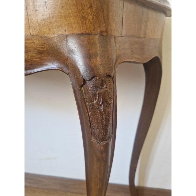 A refined walnut wall console table dating back to the 1940s, a perfect example of Louis XV-style craftsmanship. The piece...