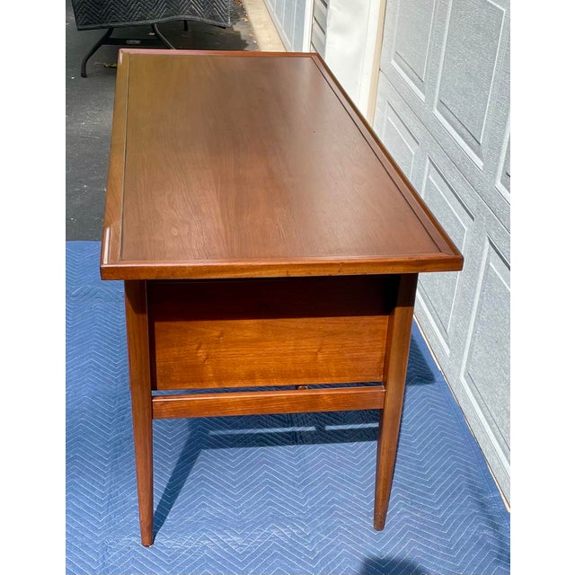 An exceptional, verified first-generation mid-century modern walnut writing desk designed by Kipp Stewart and Stewart...