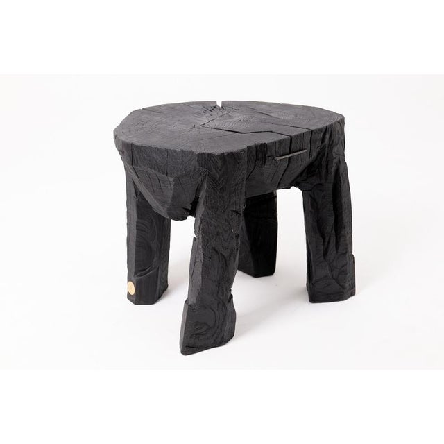 This commanding side table is a one-of-a-kind functional sculpture, hand-carved from a single solid hardwood log. Its...