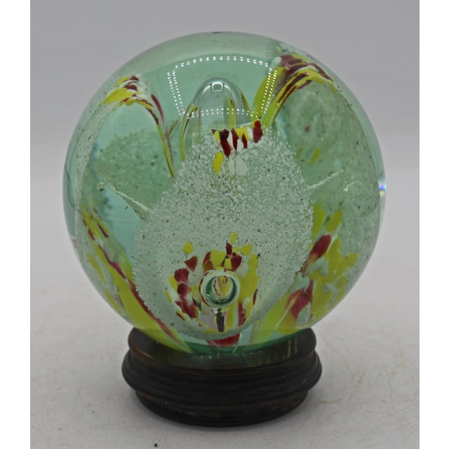 1970s large Murano floral paperweight, Italy. Retaining the unpolished extruded pontil end. Petals surround 5 clear blown...