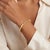 A vintage-contemporary style 14k yellow gold octagonal hinged bracelet. This piece features a sleek, minimalist design...