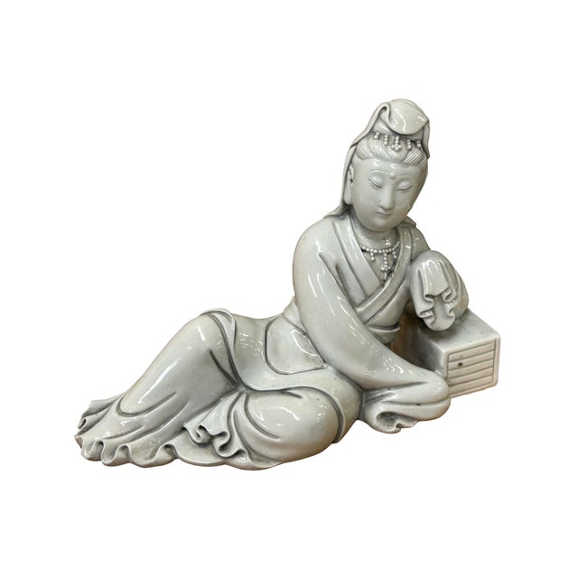 This ceramic figure depicts Guanyin, the Bodhisattva of Compassion, in a serene reclining posture (Water-Moon or Royal...