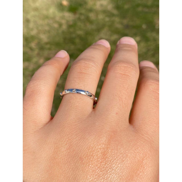 The Hap: White Gold Rosary Cross Band. This elegant ring features a central cross embossed horizontally from East to West,...