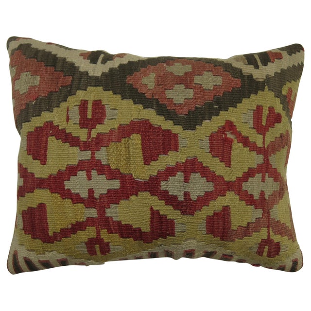 Pillow made from a vintage Turkish kilim with cotton back. Zipper closure and foam insert provided. Measures: 15" x 19".