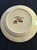 The Nathalie Lete Joyeaux Noël Dinner Plate is a round ceramic plate featuring a polka dot pattern and a charming sheep...