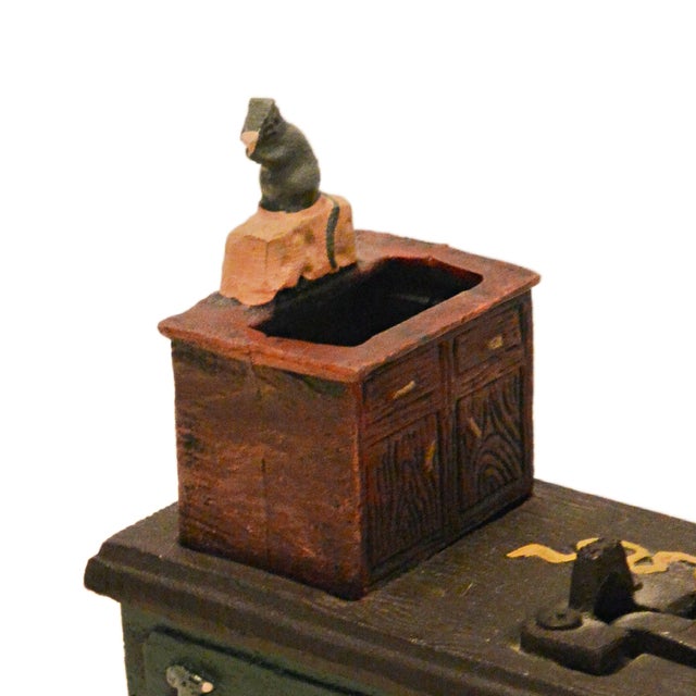 Add a touch of Victorian-inspired whimsy to your shelves with this heavy-duty cast iron mechanical bank. Titled "Cat and...