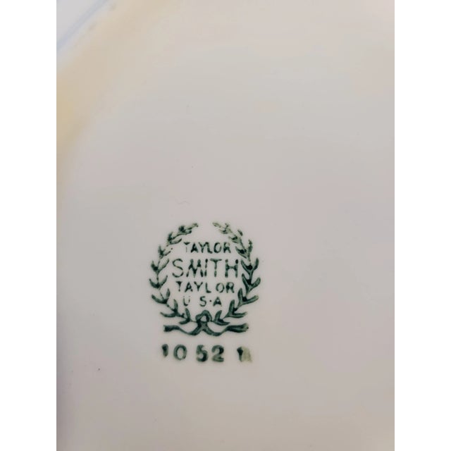 Beautiful display plate done in transferware by Taylor, Smith, and Taylor pattern number 1052 It's a view of home life in...